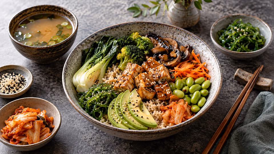A bowl with grains, vegetables, chickpeas and avocado.